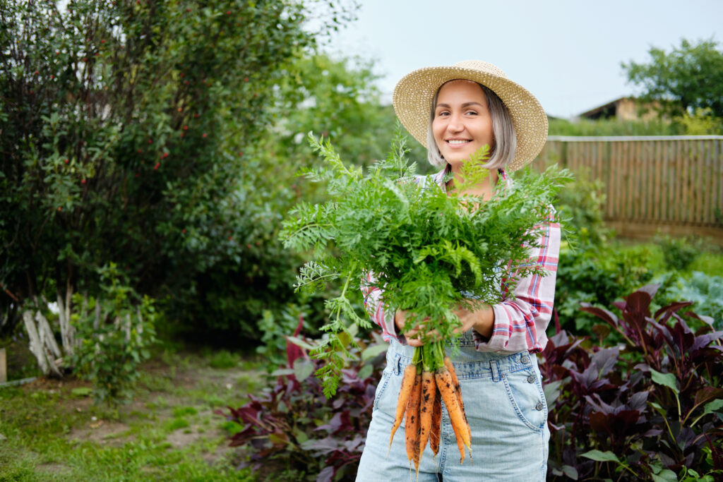 Lady with garden carrots